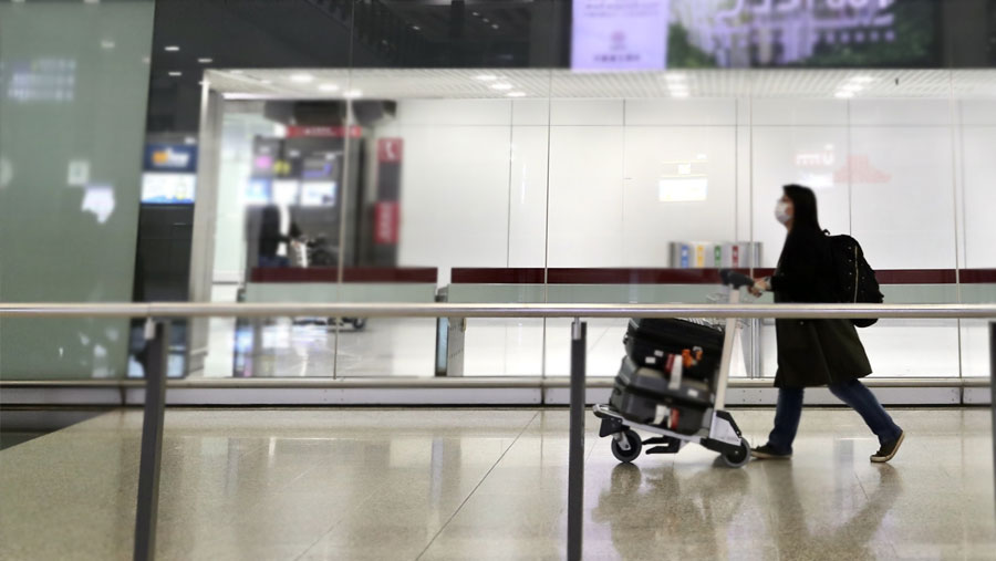 Hong Kong halves flight suspensions triggered by virus